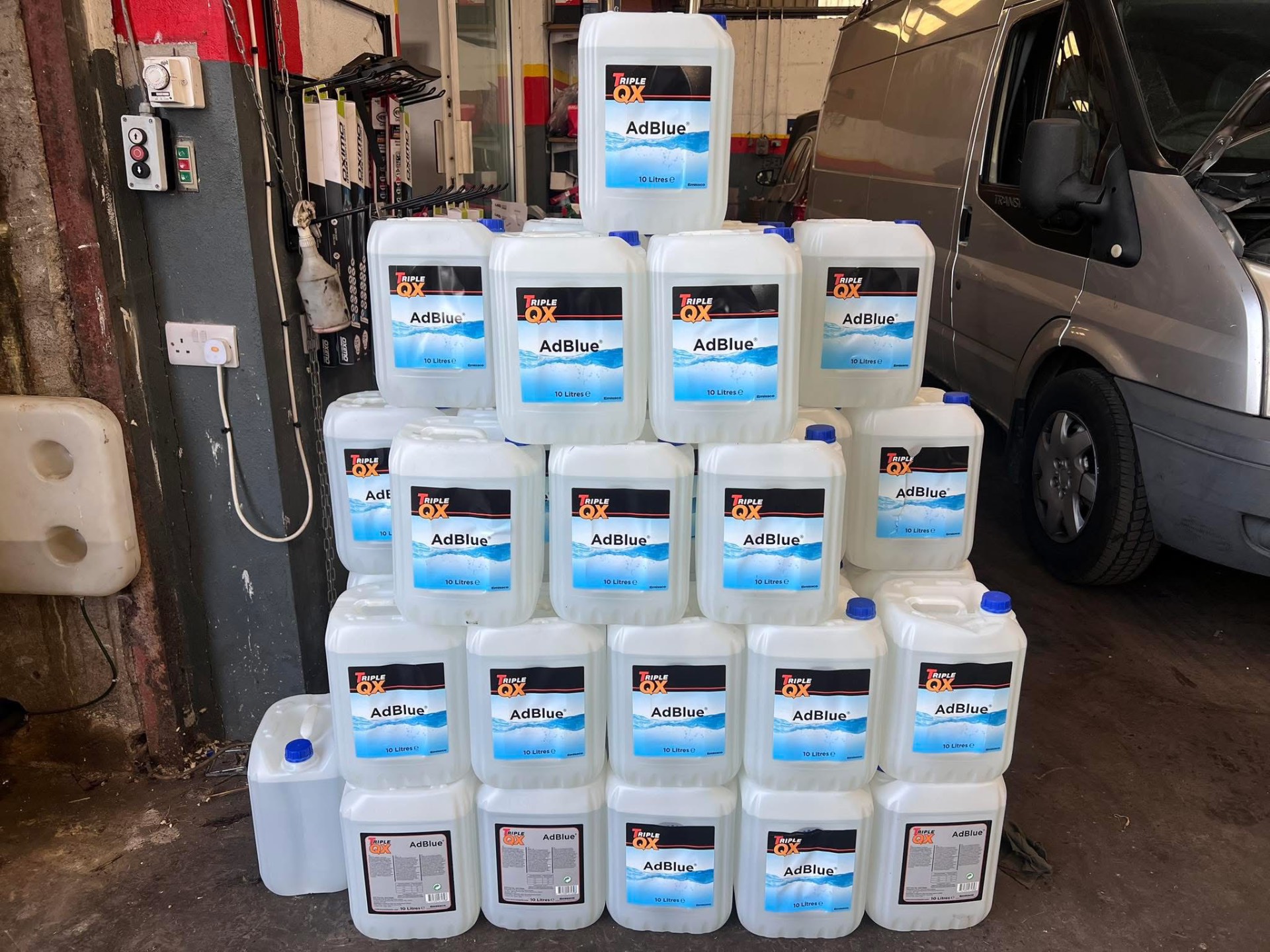 Stack of AdBlue drums ready for collection in the workshop