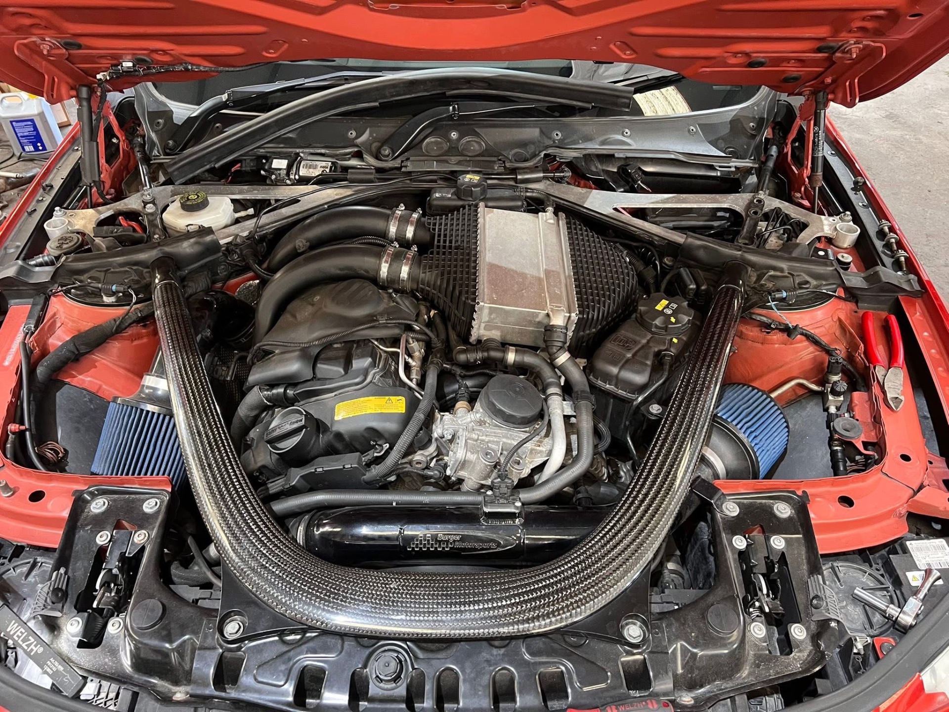 BMW M engine bay with carbon intake and uprated charge pipes