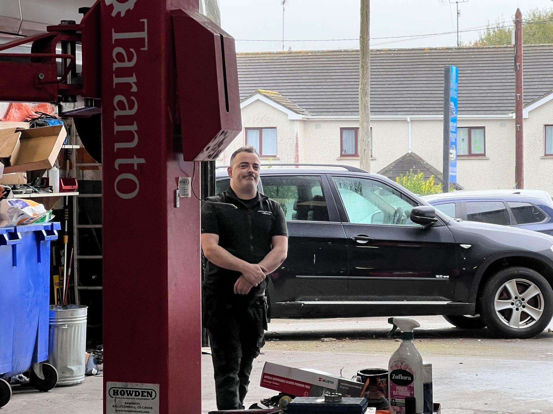 Sean Weldon standing in the workshop beside the lift